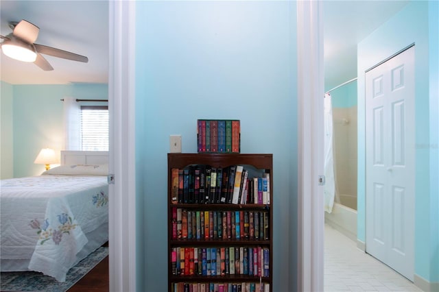 tiled bedroom featuring ceiling fan