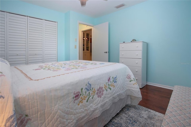 bedroom with wood-type flooring, a closet, and ceiling fan