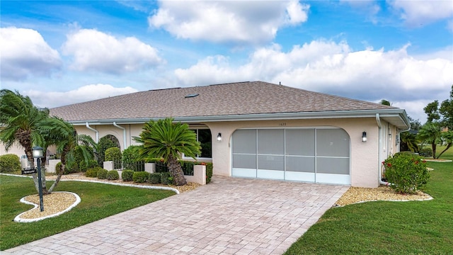 ranch-style house featuring a front yard and a garage