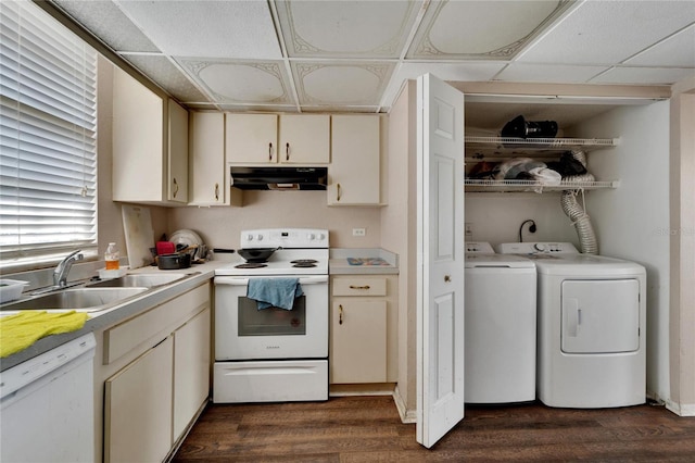 kitchen featuring white appliances, sink, cream cabinets, washing machine and dryer, and dark hardwood / wood-style floors