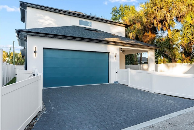 exterior space featuring ceiling fan and a garage