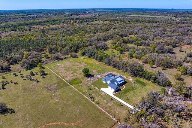 birds eye view of property with a forest view