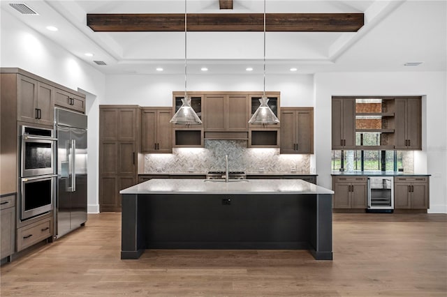 kitchen with beverage cooler, stainless steel appliances, a sink, open shelves, and beamed ceiling