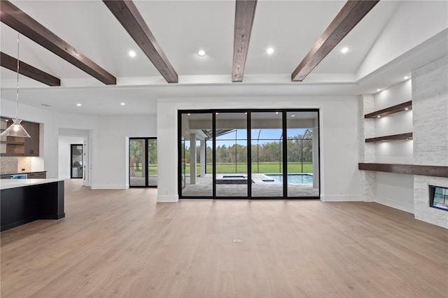 unfurnished living room with light wood-style floors, a stone fireplace, and baseboards