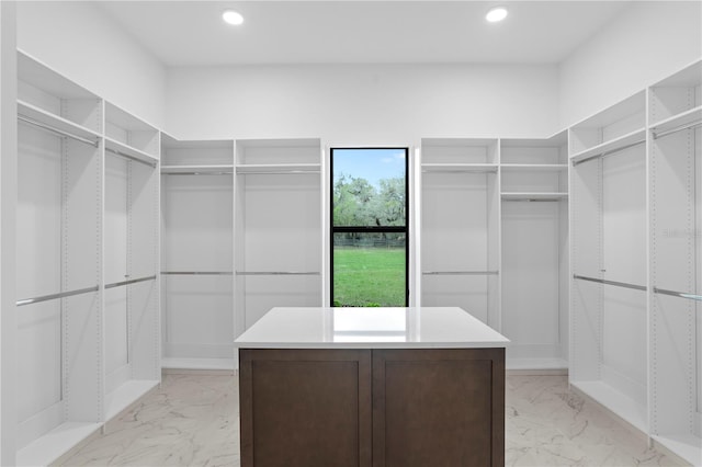 spacious closet featuring marble finish floor