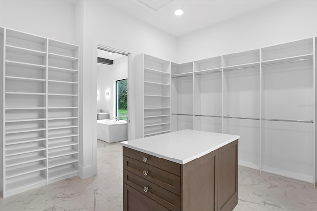 walk in closet with marble finish floor