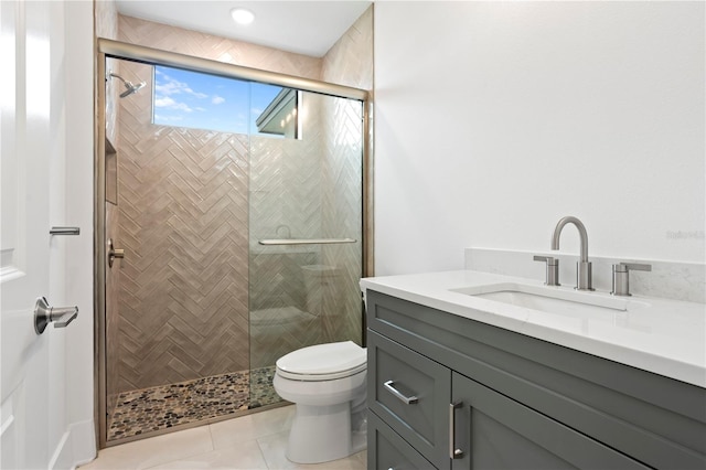 bathroom with a stall shower, tile patterned flooring, vanity, and toilet