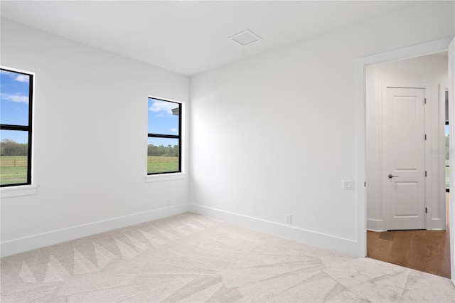 empty room featuring carpet floors and baseboards