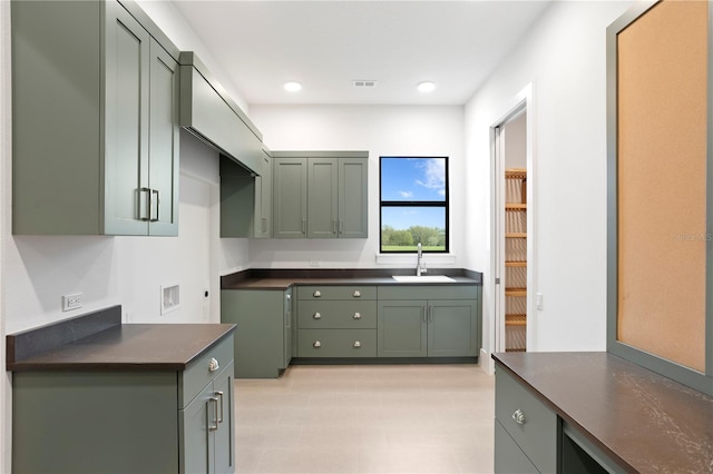 kitchen with recessed lighting, a sink, visible vents, dark countertops, and green cabinetry