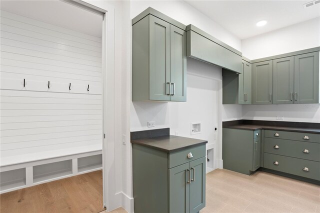 kitchen featuring recessed lighting, visible vents, light wood-style floors, green cabinets, and dark countertops