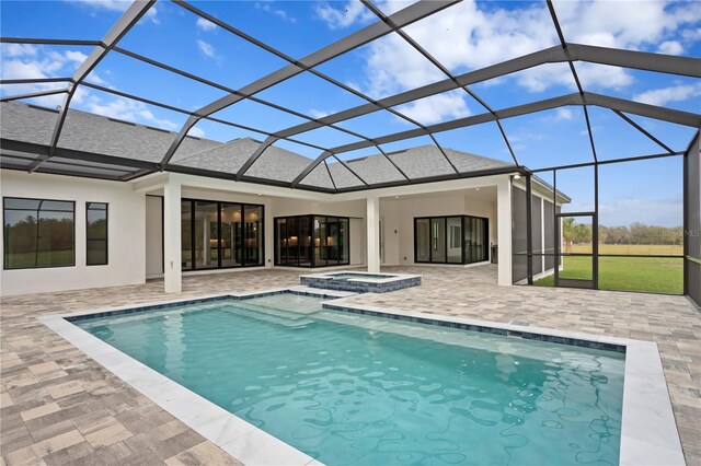 back of property featuring roof with shingles, a patio, stucco siding, a pool with connected hot tub, and a lanai