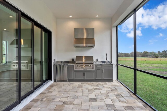 unfurnished sunroom with a sink and a rural view