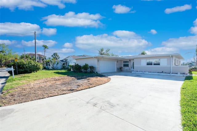 single story home with a front yard and a garage