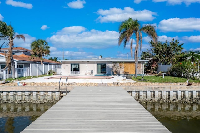 dock area with a water view and a patio