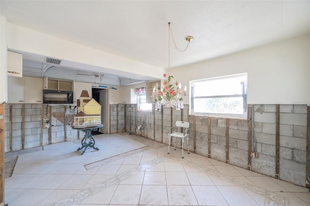 basement featuring light tile patterned floors