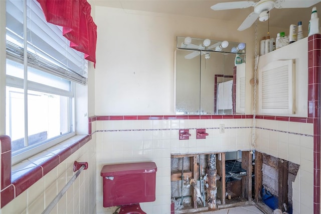 bathroom with ceiling fan and tile walls