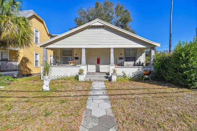 bungalow-style home with a front yard