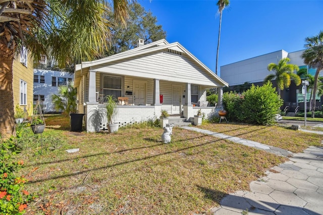 bungalow-style home featuring a front lawn