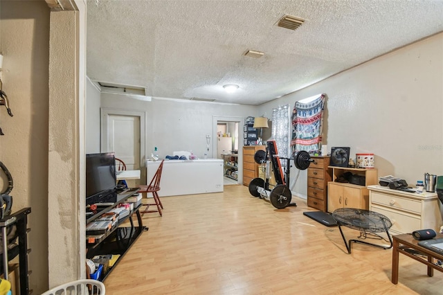 interior space with light hardwood / wood-style floors and a textured ceiling