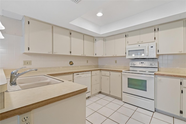 kitchen featuring tasteful backsplash, white appliances, sink, white cabinetry, and light tile patterned flooring