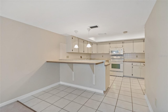 kitchen with kitchen peninsula, decorative backsplash, white appliances, light tile patterned floors, and decorative light fixtures