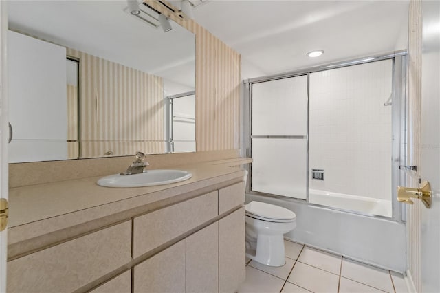 full bathroom with tile patterned floors, toilet, vanity, and combined bath / shower with glass door