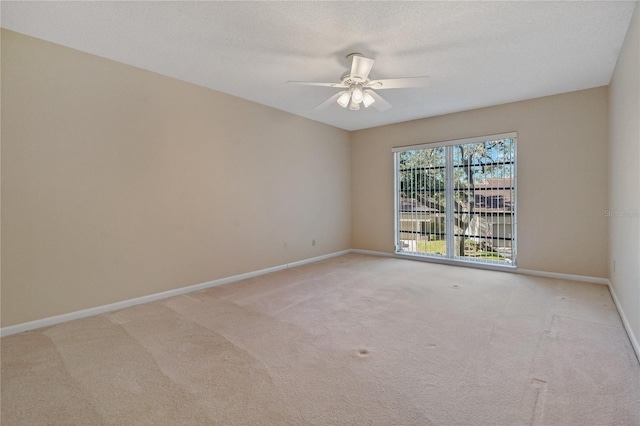 empty room with a textured ceiling, ceiling fan, and light carpet