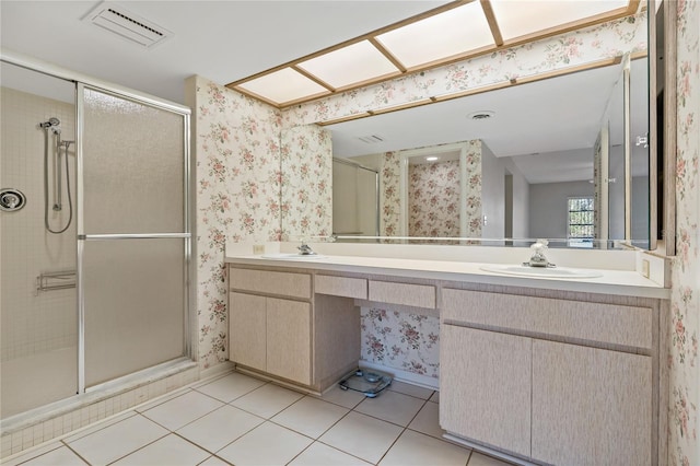 bathroom with tile patterned flooring, vanity, and a shower with door