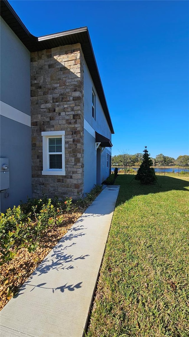 view of property exterior featuring a lawn