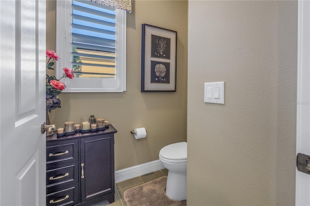 bathroom with tile patterned flooring and toilet