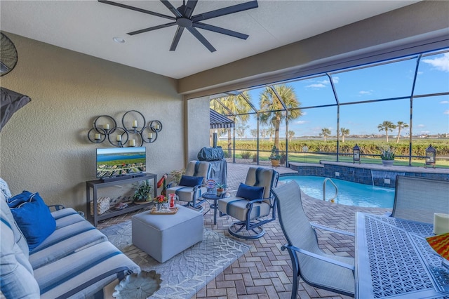 view of patio with glass enclosure, ceiling fan, and pool water feature