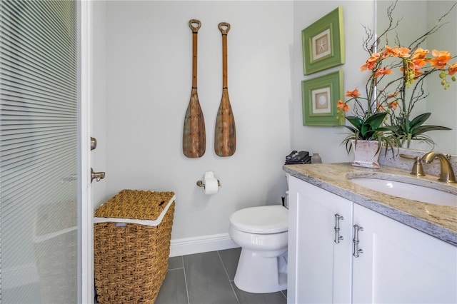 bathroom featuring tile patterned floors, vanity, and toilet