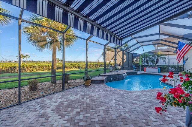 view of swimming pool featuring glass enclosure, pool water feature, and a patio