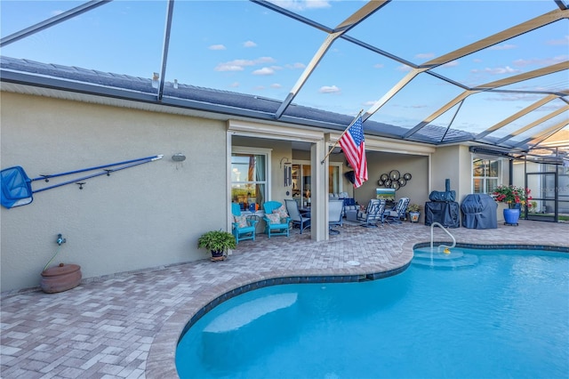 view of swimming pool with a lanai and a patio area