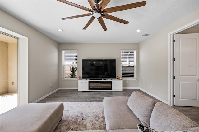 10551 Tranquil Meadow Loop, Riverview, FL 33569 - living area with wood finished floors, ceiling fan, baseboards, recessed lighting, and a textured ceiling