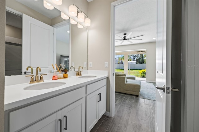 bathroom with ceiling fan, wood-type flooring, and vanity