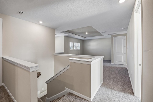 10551 Tranquil Meadow Loop, Riverview, FL 33569 - hallway with an upstairs landing, light carpet, a textured ceiling, recessed lighting, and baseboards