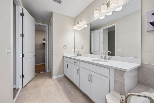 10551 Tranquil Meadow Loop, Riverview, FL 33569 - full bathroom featuring double vanity, a bathtub, and a walk in closet