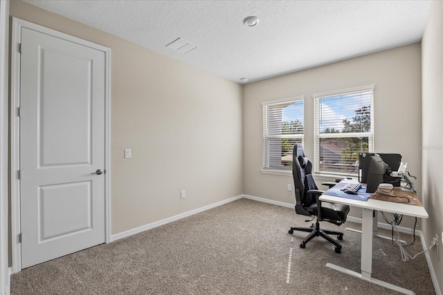 home office with a textured ceiling and carpet floors