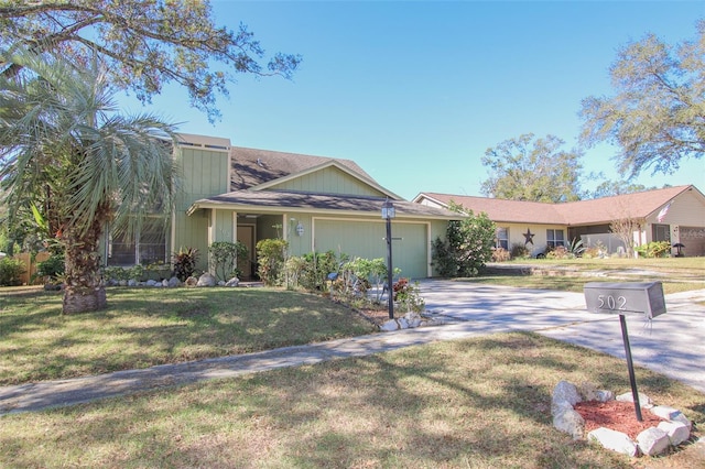 single story home featuring a garage and a front lawn