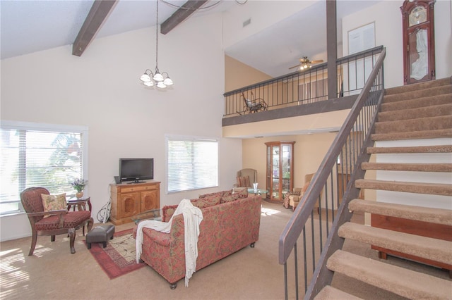 living room with a wealth of natural light, beamed ceiling, high vaulted ceiling, and ceiling fan with notable chandelier