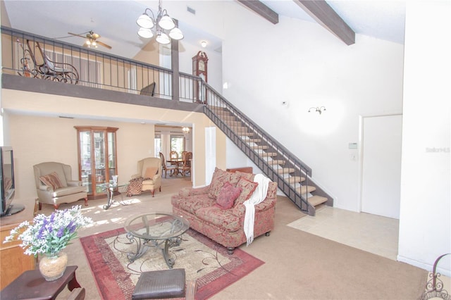 living room with ceiling fan with notable chandelier, beam ceiling, light carpet, and high vaulted ceiling