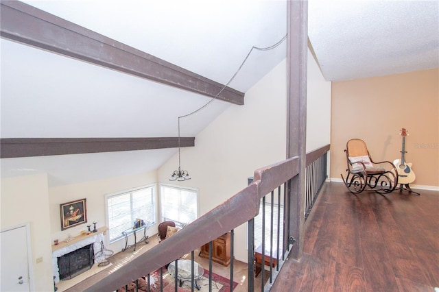 corridor with dark wood-type flooring, lofted ceiling with beams, and an inviting chandelier