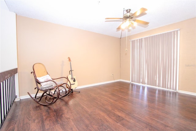 living area featuring ceiling fan and dark wood-type flooring