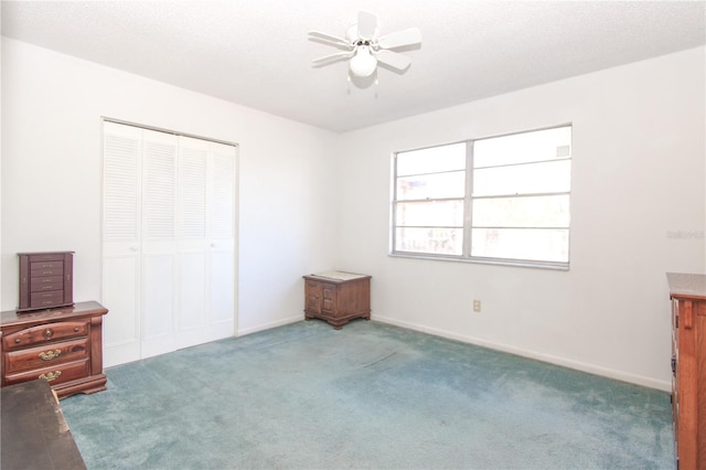 unfurnished bedroom featuring carpet, a closet, and ceiling fan