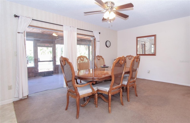 carpeted dining area featuring ceiling fan