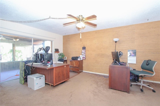 office space with light carpet, a textured ceiling, and ceiling fan