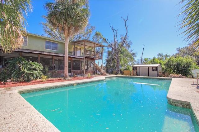 view of swimming pool with a storage shed