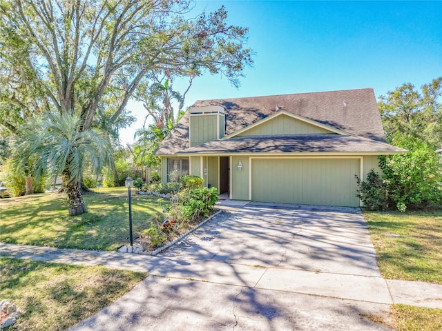 view of front of home with a garage and a front lawn