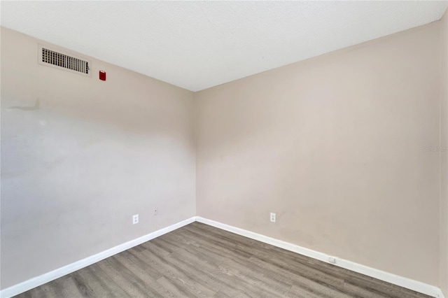 spare room with dark wood-type flooring